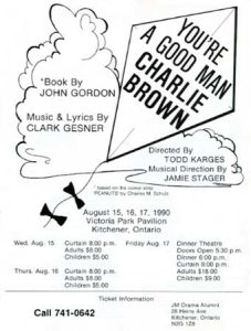 1990 You're a Good Man Charlie Brown promotional poster with white background and bold cartoon-style design. Top features hand-drawn title treatment reading "A YOU'RE A GOOD MAN, CHARLIE BROWN" with playful lettering inside cloud-like shape. Below shows "Book by JOHN GORDON" and "Music & Lyrics by CLARK GESNER" with additional credits. Main visual element is simple line drawing of Snoopy's iconic doghouse with pennant flag on top. Production information: "Presented by TODD KARGES, Directed by Bill Klaus, Musical Direction by Dave McColman." Performance dates extensively listed: "August 10, 11, 12, 17, 1990" at "Victoria Park Pavilion (Schneiders Creek) Kitchener, Ontario" with show time "Adults $6.50, Children $3.50" and "Meal: Aug. 10, 11, 17 Lunch served 12 Noon-1:00, Roast Beef Dinner, Doors Open 5:30 p.m., Dinner 6:00 p.m., Show 7:30 p.m., Children $3.50." Additional shows at other dates with phone "Call 741-0642" for reservations. Bottom shows JM Drama Alumni information. Simple, cheerful design perfectly capturing the Peanuts comic strip aesthetic. Hand-lettered feel and minimalist illustration evoke Charles Schulz's original artwork. Friendly, accessible design appropriate for family-friendly musical.